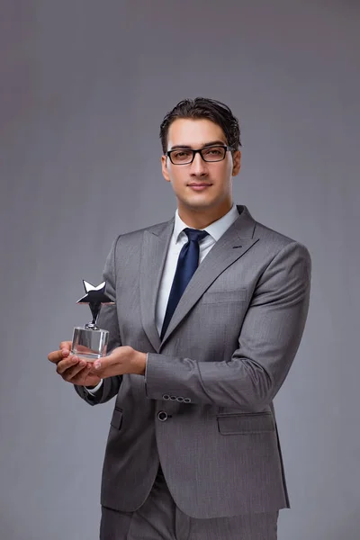 Businessman holding star award in business concept — Stock Photo, Image