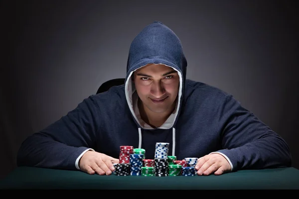 Young man wearing a hoodie with cards and chips gambling — Stock Photo, Image