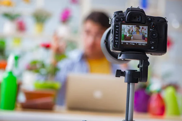 Чоловік квітка садівник відеоблогер знімає відео на камеру — стокове фото