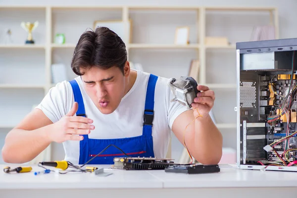 Computer repairman repairing desktop computer