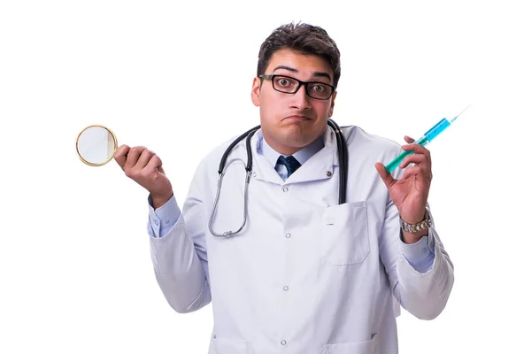 Young doctor with a magnifying glass and a syringe isolated on w — Stock Photo, Image