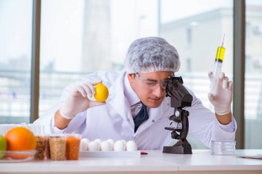 Besin uzmanı gıda ürünlerini laboratuarda test ediyor.