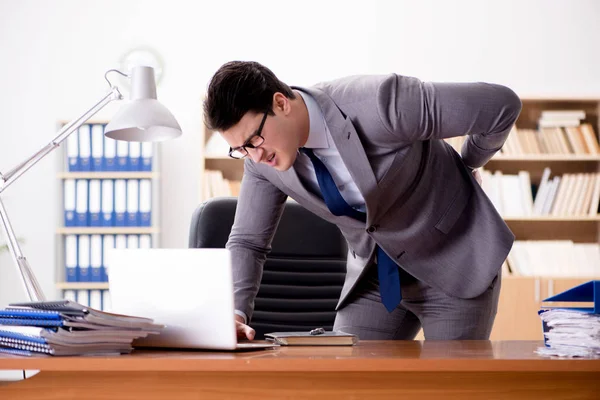 Empresario sintiendo dolor en la oficina — Foto de Stock