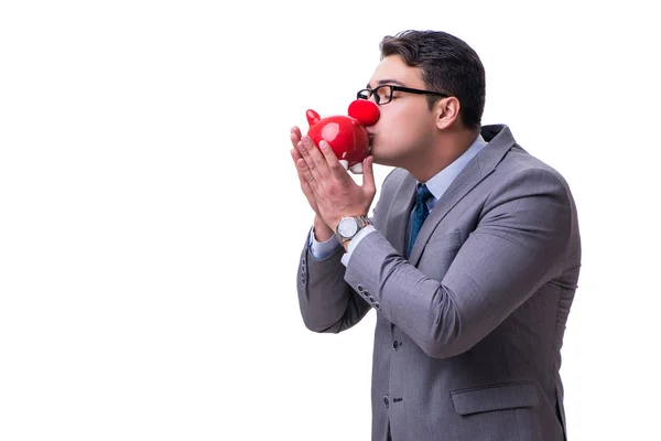 Rolig clown affärsman med en spargris som isolerade på vit baksida — Stockfoto