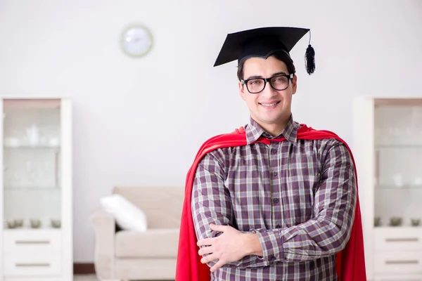 Super hero student wearing mortarboard in a red cloak — Stock Photo, Image
