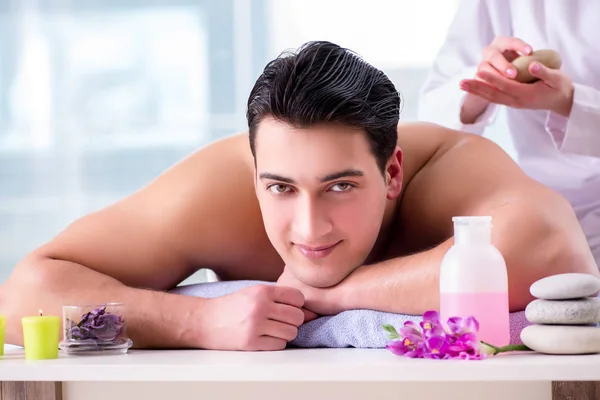 Handsome man in spa massage concept