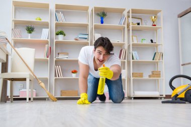 Adam evi temizliyor.