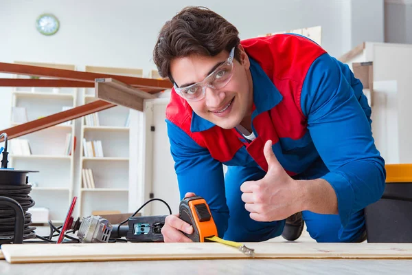 Young carpenter working with wooden planks — Stock Photo, Image