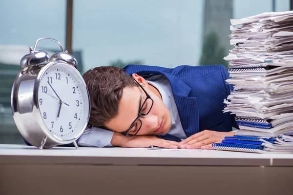 Businessman with pile stack of paper paperwork and an alarm cloc — Stock Photo, Image