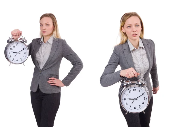 Mujer de negocios en traje gris con reloj despertador aislado en blanco — Foto de Stock