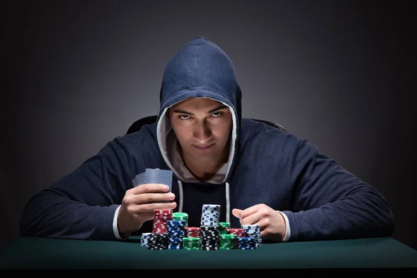 Young man wearing a hoodie with cards and chips gambling — Stock Photo, Image