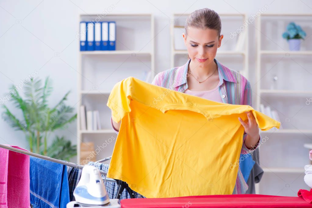 Young housewife doing laundry at home