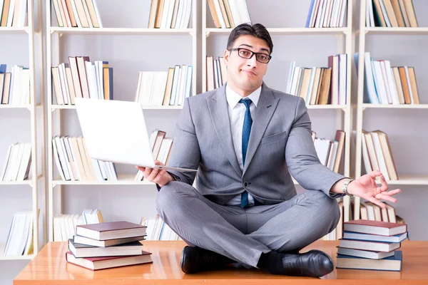 Businessman student in lotus position meditating with a laptop i — Stock Photo, Image