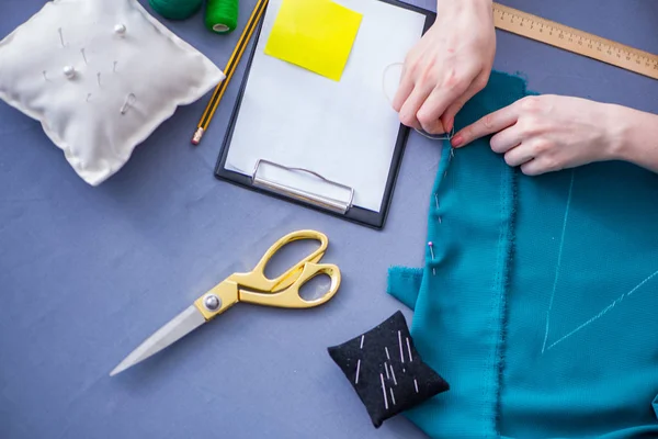 Woman tailor working on a clothing sewing stitching measuring fa — Stock Photo, Image