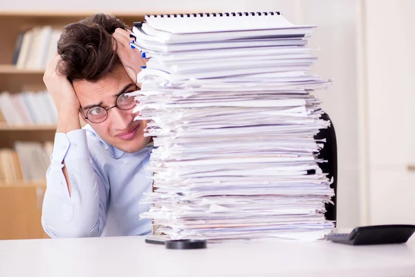 Mad businessman with piles of papers Stock Photo