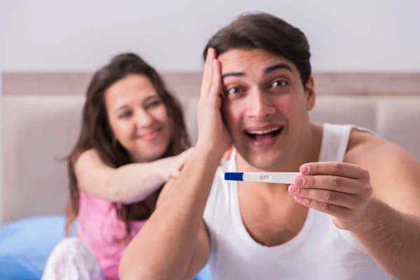 Young family with pregnancy test results — Stock Photo, Image