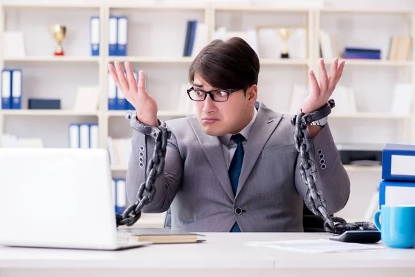 Businessman tied with chains to his work — Stock Photo, Image