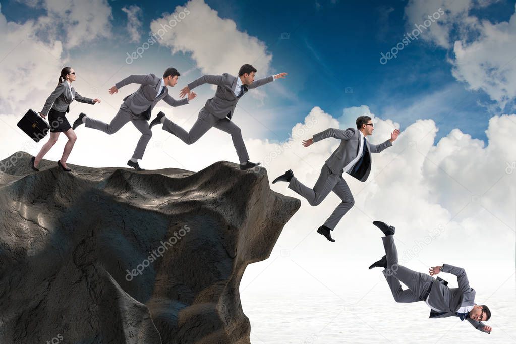 Business people falling off the cliff