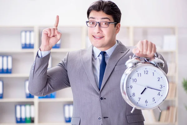 Businessman with alarm clock in the office — Stock Photo, Image