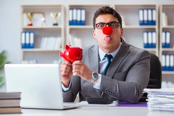 Clown businessman with piggy bank doing accounting