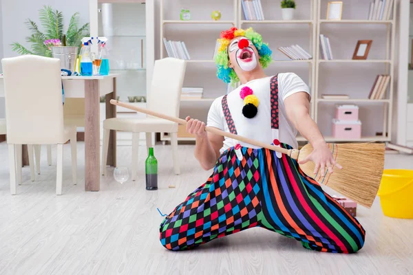 Funny clown doing cleaning at home — Stock Photo, Image