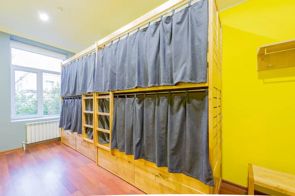 Hostel dormitory beds arranged in room — Stock Photo, Image