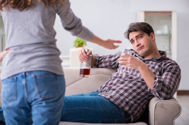 Genç bir aile kavramında içki sorunu yaşayan sarhoş bir koca.