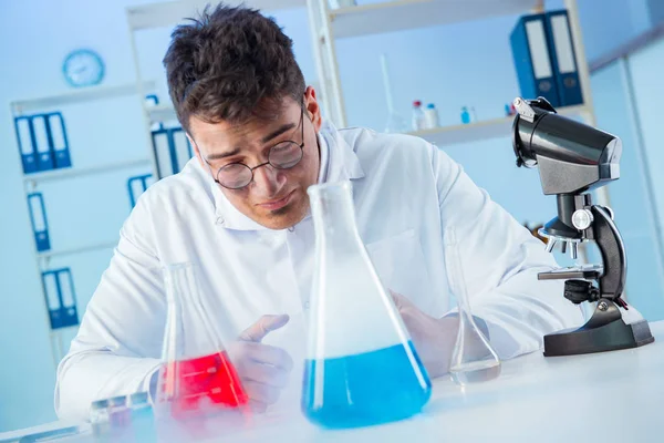 Funny mad chemist working in a laboratory — Stock Photo, Image