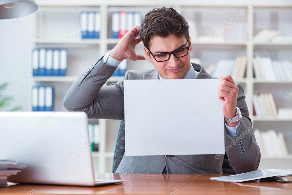 Businessman  in office holding a blank message board