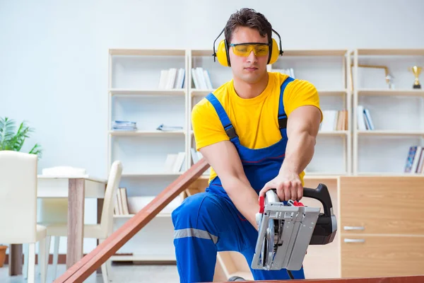 Tamirci marangoz. Dolaşım halindeki tahta testereyi kesiyor.