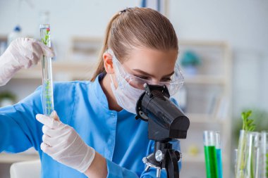 Bir laboratuarda deney yapan kadın bir bilim adamı.