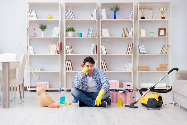 Adam evi temizliyor.