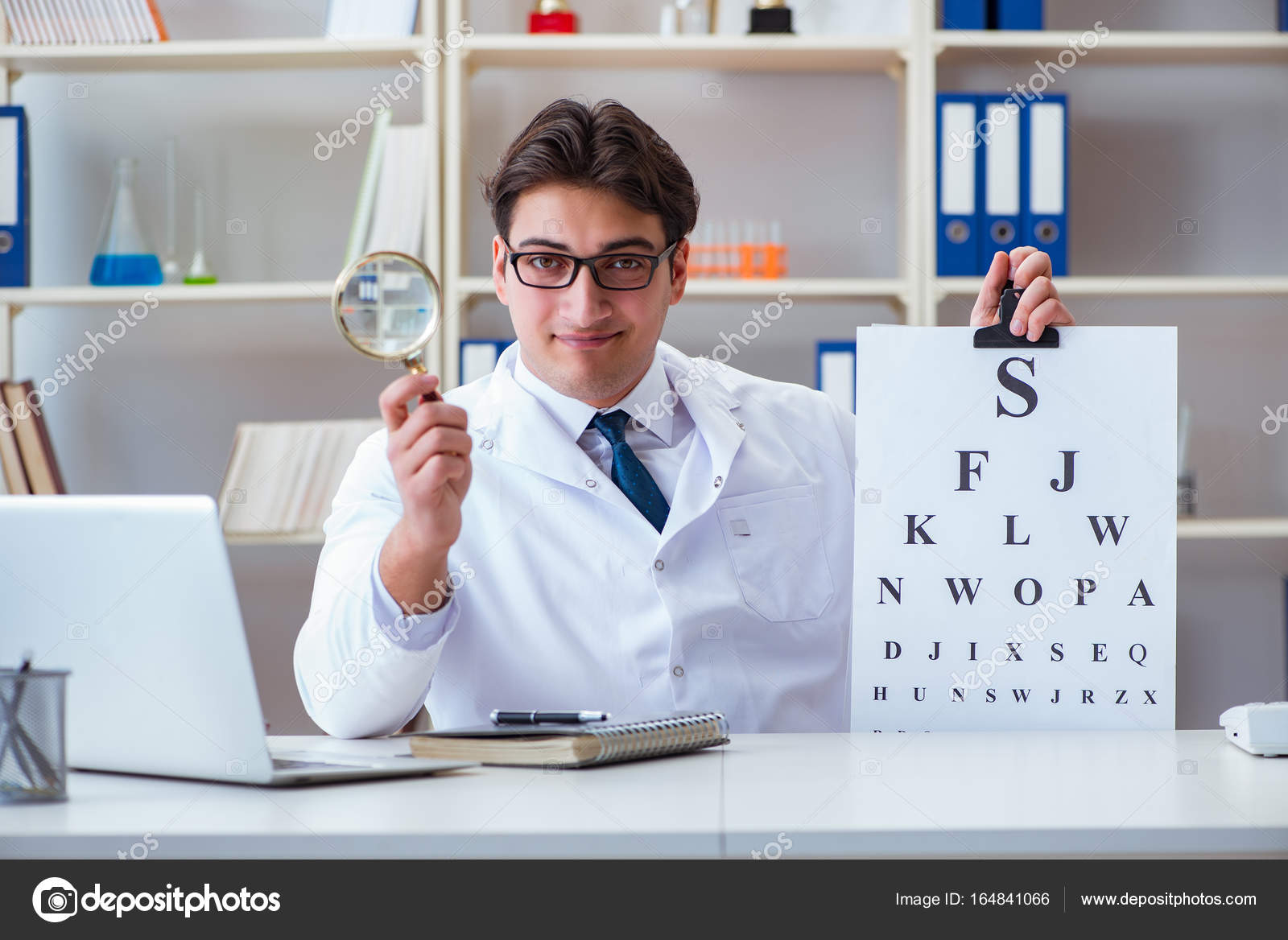 Doctor Optician With Letter Chart Conducting An Eye Test Check
