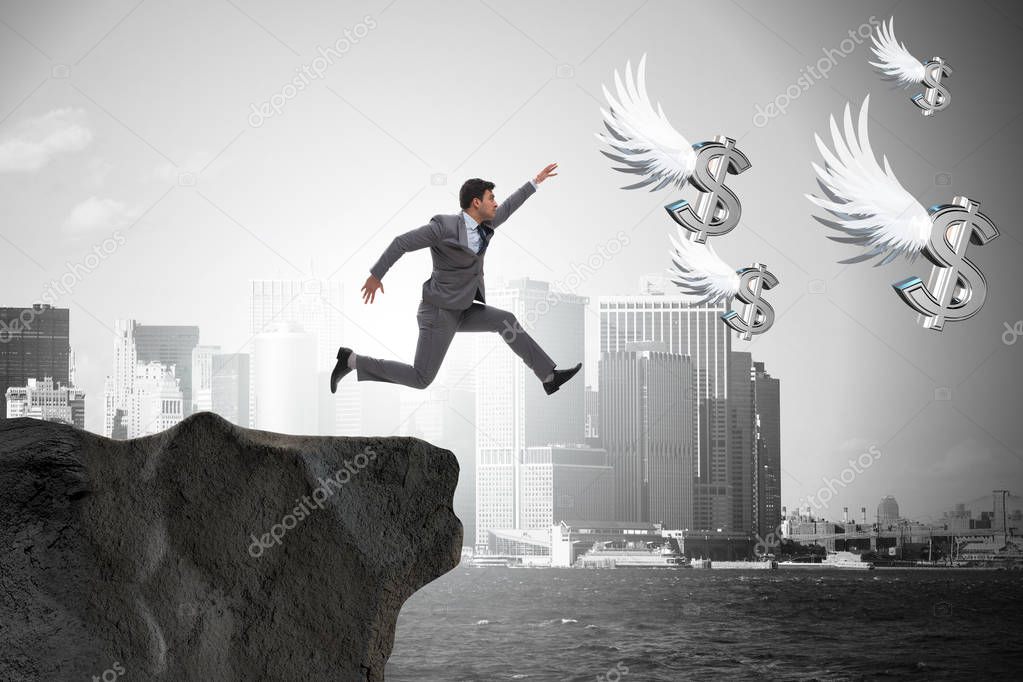 Businessman chasing angel dollars in business concept