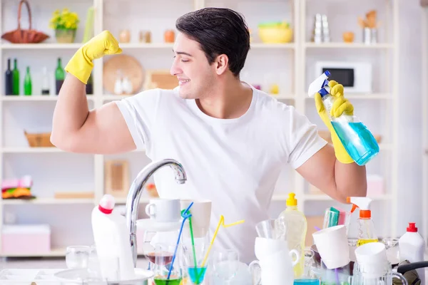 Good husband washing dishes at home — Stock Photo, Image