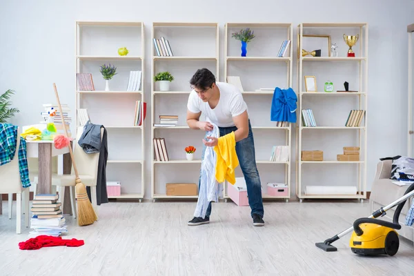 Adam evi temizliyor.