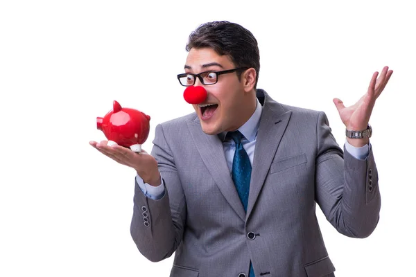 Rolig clown affärsman med en spargris som isolerade på vit baksida — Stockfoto