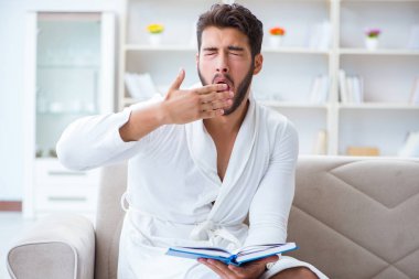 Öğrenci işadamı genç adam bir kitap okuyor.