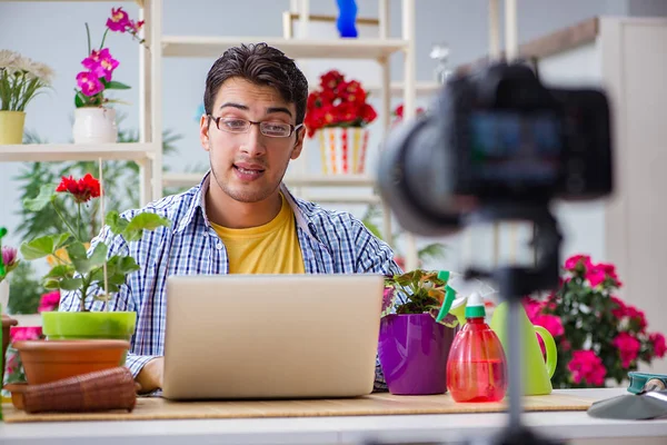 Man florist gardener vlogger blogger shooting video on camera