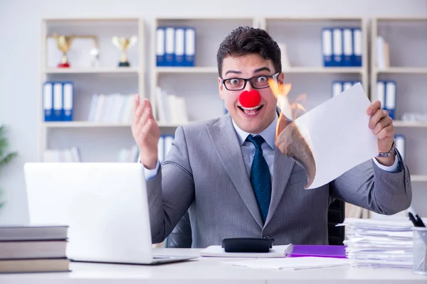 Clown homme d'affaires brûlant des papiers dans le bureau — Photo