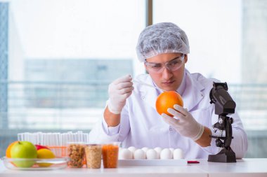 Besin uzmanı gıda ürünlerini laboratuarda test ediyor.