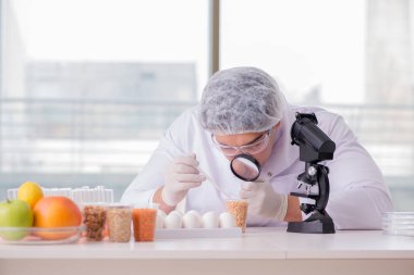 Besin uzmanı gıda ürünlerini laboratuarda test ediyor.