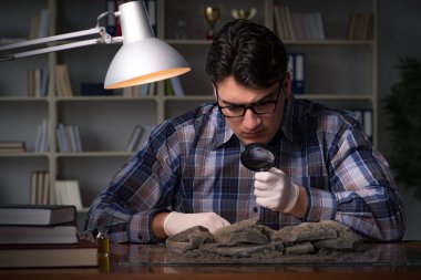 Arkeolog geç saatlere kadar ofiste çalışıyor.