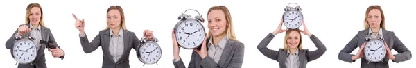 Mujer de negocios en traje gris con reloj despertador aislado en blanco — Foto de Stock