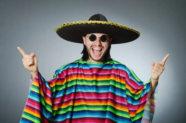 Man in a vivid mexican poncho gray background isolated — Stock Photo, Image