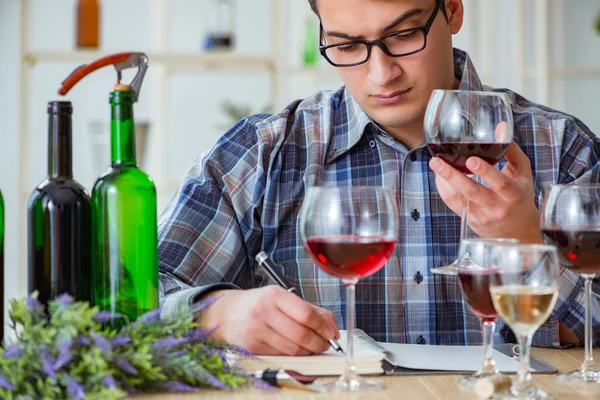 Professional sommelier tasting red wine