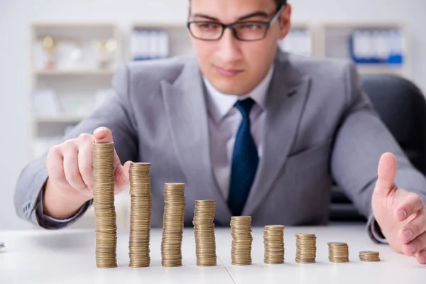 Businessman with golden coins in business growth concept — Stock Photo, Image