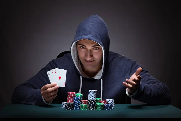 Young man wearing a hoodie with cards and chips gambling — Stock Photo, Image