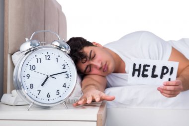 Yatakta uykusuzluk çeken bir adam.