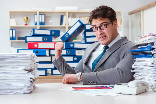 Businessman busy with much paperwork